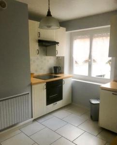 a kitchen with a sink and a stove top oven at Le Courancon in Saint-Nectaire