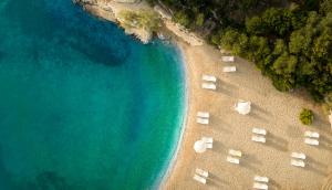 an overhead view of a beach with chairs and the water at Aminess Port 9 Residence in Korčula