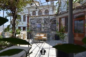 a patio of a house with a table and chairs at Guest House Bake in Gjirokastër
