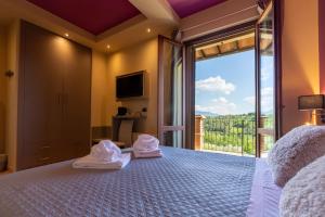 a bedroom with a large bed with a large window at Agriturismo AgrileisureTime in Spoleto +196 photos