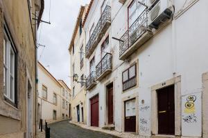 eine Gasse in einer Altstadt mit Gebäuden in der Unterkunft Alfama First Floor in Lissabon