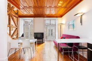 ein Wohnzimmer mit einem Tisch und einem Sofa in der Unterkunft Alfama First Floor in Lissabon