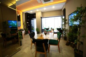 a living room with a table and chairs and a large window at taksim diamond hotel in Istanbul