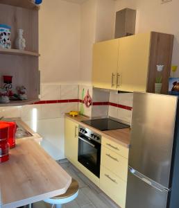 a kitchen with a stove and a refrigerator at M24 in Hecklingen