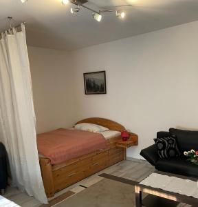 a bedroom with a bed and a couch at M24 in Hecklingen