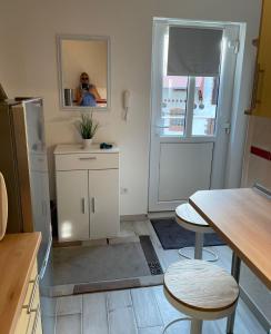 a kitchen with a refrigerator and a table and chairs at M24 in Hecklingen
