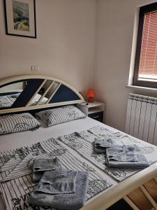 a bedroom with a bed with two towels on it at House Čeh in Črni Kal