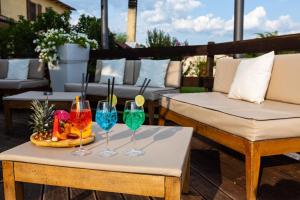 a table with two chairs and wine glasses on a patio at Agriturismo AgrileisureTime in Spoleto