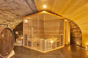 a large glass room with a barrel in a cave at Burgblickhotel in Bernkastel-Kues