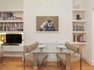 a dining room with a glass table and chairs at 7 Mount Sion in Royal Tunbridge Wells