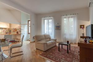 a living room with a couch and a table at Apartments Florence - Libertà Loft in Florence