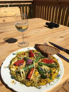 a plate of food on a table with a glass of wine at Ferienhaus Trausibauer in Stainz