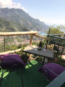 a balcony with a table and two glasses of wine at Appartamento a Ravello in Ravello