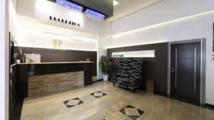 a lobby with a reception desk and a black door at Pollock Hotel, Ribarska Banja in Ribarska Banja +101 photos