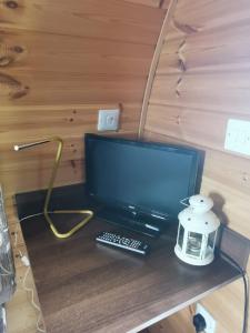 a laptop computer sitting on a desk with a lamp at Rockinghams Farm in Layer Marney