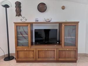 a wooden entertainment center with a flat screen tv at House Čeh in Črni Kal