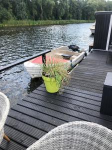 a dock with two boats on a body of water at gardenhouse mariposa in Badhoevedorp