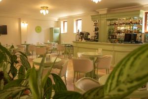 a restaurant with tables and chairs and a bar at Hotel Russia in Tsaghkadzor