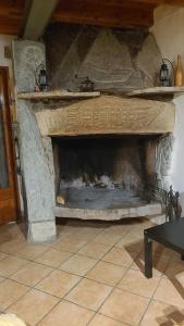 a stone fireplace in a living room at Casa Pirineu in Esterri de Cardós