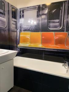 a subway train with orange seats and a sink at Amiens LOFT in Amiens +68 photos