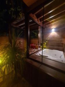 a jacuzzi tub in a house at night at Pousada Vila Rosada in Florianópolis