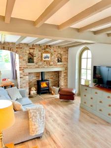 a living room with a couch and a fireplace at Old Chapel House Tetney Lock in Grimsby