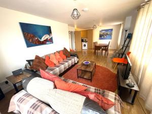 a living room with a couch and a table at Modern Apartment near Tower Bridge in London