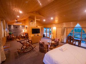 a bedroom with a bed and a living room at La Vita Nuova Resort & Spa in Shaugaon