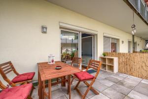 a wooden table and chairs on a patio at Arbio I Homely Apart in Sudvorstadt Leipzig in Leipzig