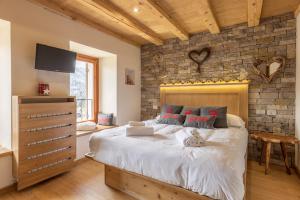 a bedroom with a bed with a cat laying on it at Casa Ladinia in San Vito di Cadore