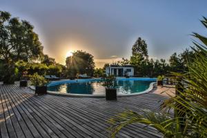 穆龍達瓦的住宿－KIMONY RESORT，一个带木甲板和房子的游泳池