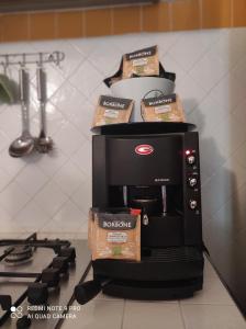 a coffee maker with boxes on top of it at Guest House Di Bartolomeo in Capaccio-Paestum