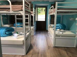 a room with four bunk beds with blue walls at Villa Palatina in Bolgues