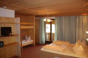 a bedroom with a bed and a television in a room at Ferienhof Kampfl in Fügen