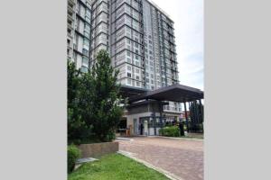 a large building with a bus stop in front of it at Shaftesbury Residences Cyberjaya Studio Suites Free Parking in Cyberjaya