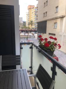 a balcony with a bench and flowers on a building at La Rosa Apartment Los Boliches Fuengirola Malaga Spain in Fuengirola