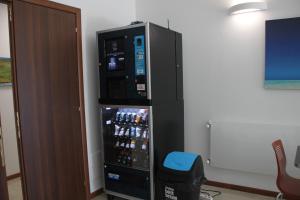 a refrigerator filled with bottles of beer in a room at EKOTEL in Rome