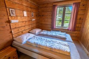 Ein Bett oder Betten in einem Zimmer der Unterkunft Å-Hamna Rorbuer