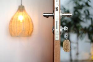 a wooden door with a padlock attached to it at Telescope Resort Lombok in Kuta Lombok