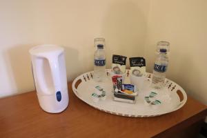 a table with two bottles of water on a counter at St George's Lodge, Bisley in Brookwood