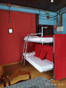 a room with two bunk beds and a red wall at Casa Josefita in Villamayor +47 photos