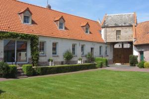 a large white house with an orange roof at Le Bout du Monde in Berneville