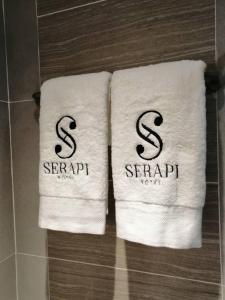 two towels on a rack in a bathroom at Serapi Verdure Hotel in Kuching