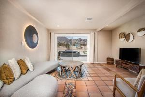a living room with a couch and a table at @ Marbella Lane - The Moon Designer Home right behind the JTNP in Joshua Tree