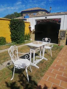 een witte tafel en stoelen in een tuin bij Room in Lovely cottage house Habitaciones en Chalet en Cadiz San Fernando in San Fernando