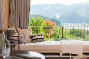 a room with a couch and a balcony with a view at Balthasar Volcano Apartments - Adults only in St. Wolfgang