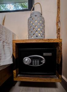 a microwave in a wooden box with a bag on top at Sunset House in Tulum