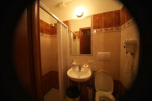 a bathroom with a sink and a toilet and a mirror at Hotel Hollywood in Rome