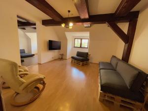 a living room with a couch and a tv at Hostel Little Quarter in Prague