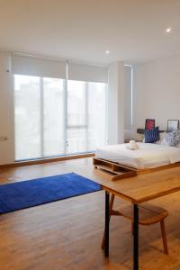 a bedroom with a bed and a blue rug at Tengah Tengah in Jakarta
